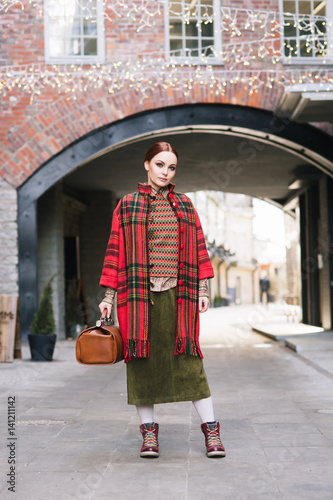 Beautiful and pretty young girl; standing in front of old house. Fashion, beauty, retro, streetlook: concept.