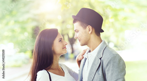 Young beautiful couple of hipsters: hugging in the park. Love, relationship, dating: concept. © Acronym