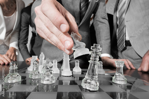 Business people playing chess