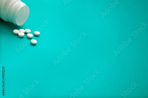 Medical green background with can and tablets.