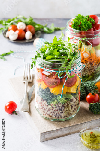 Glass jar with quinoa and vegetables salad. Healthy food, diet, detox, clean eating and vegetarian concept.