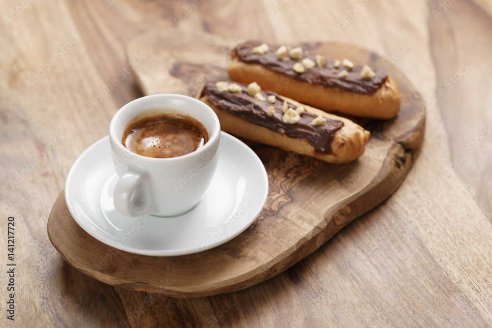 fresh espresso and eclairs with hazelnuts, sweet morning breakfast fresh espresso and eclairs with hazelnuts, sweet morning breakfast