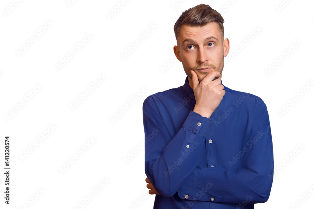 Handsome casual man thinking and looking at copyspace