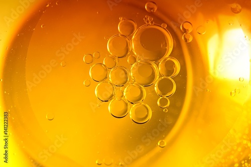 Yellow bubble oil in water abstract background.