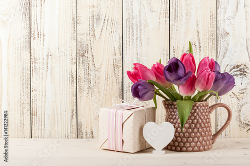 Fresh tulips, white heart and gift box