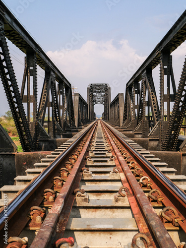 Fototapeta Naklejka Na Ścianę i Meble -  Steel structure of railway bridge, railway rail with vanishing point, amazing perspective