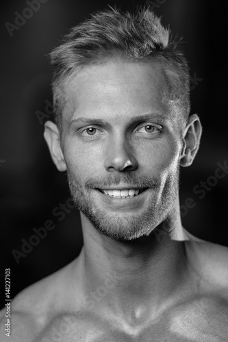 Portrait of a handsome guy on a background of gym