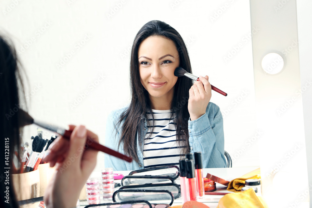 Beautiful young woman making make-up
