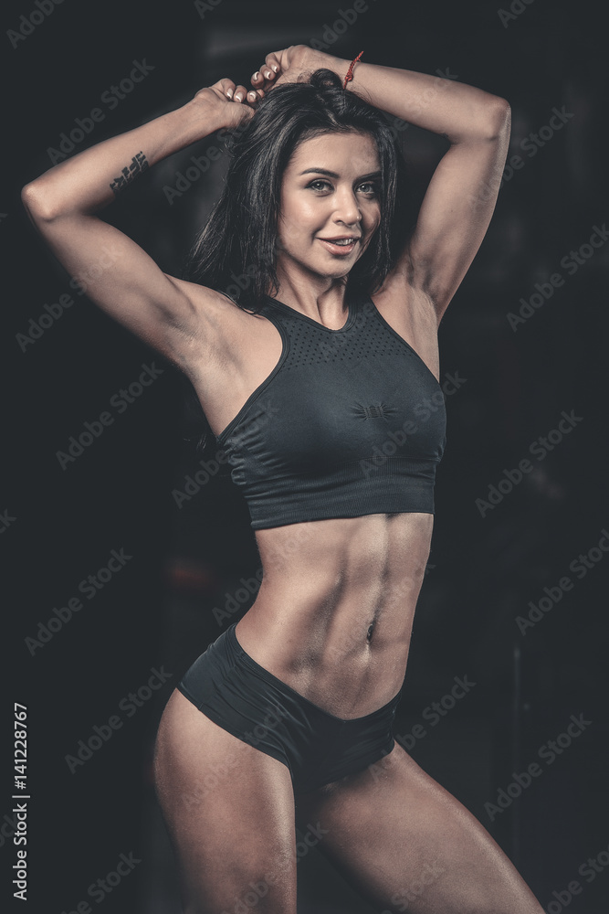 Obraz premium Sexy portrait model and tanned body looking away in gym ..