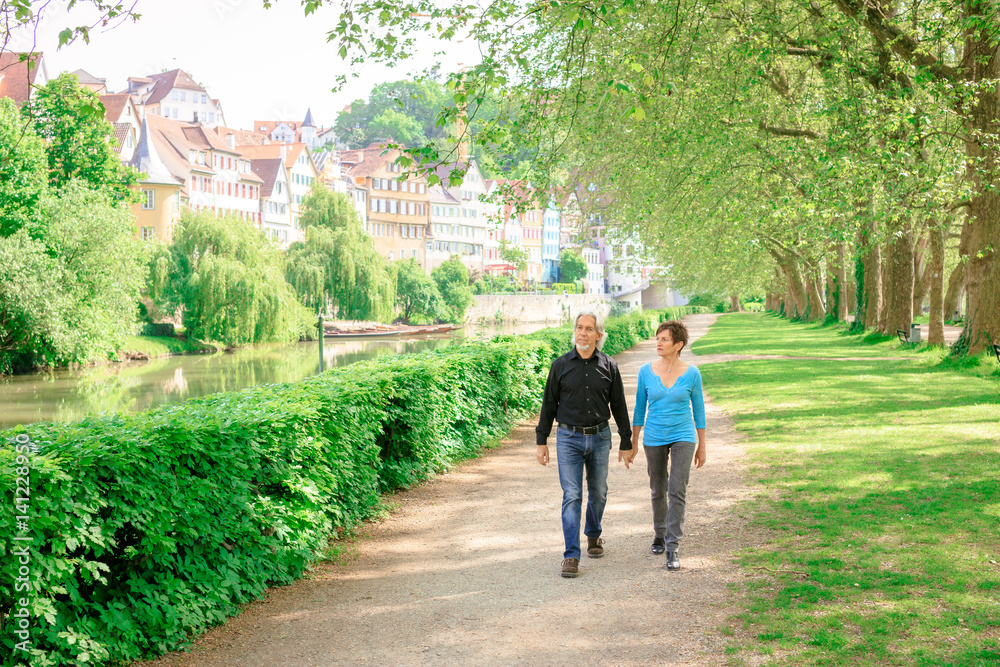 Senior Couple Walking Through A Park