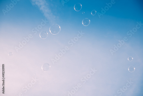 Soap bubbles against the clear blue sky