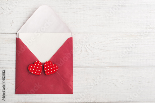 Red envelope with empty paper and red hearts