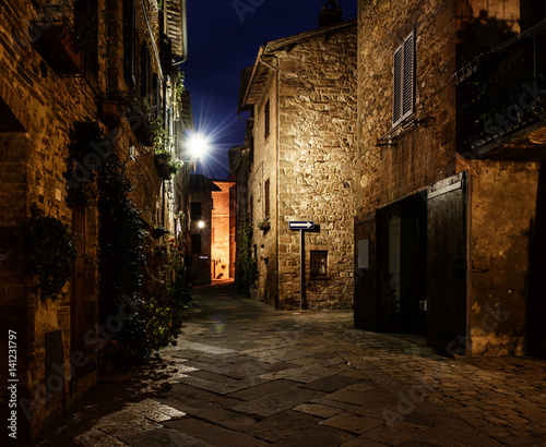 Night view of beautiful Italian medieval Pienza city with lanterns. Travel outdoor Tuscany background.