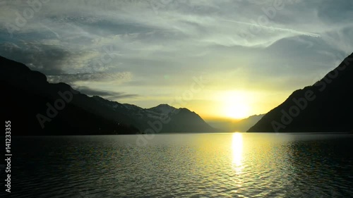 Sunset in the mountains of the Alps. Impressive clouds over the tops of the mountains. Cloudy sky above Lake Lucerne.