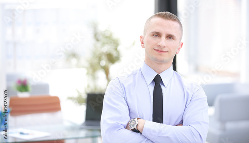 Successful businessman posing and smiling at camera