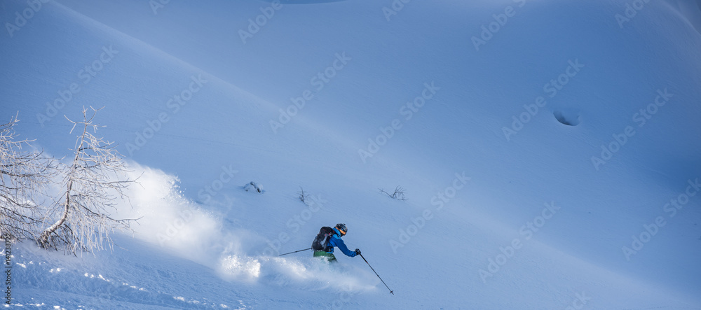 Fast free rider with clouds of snow