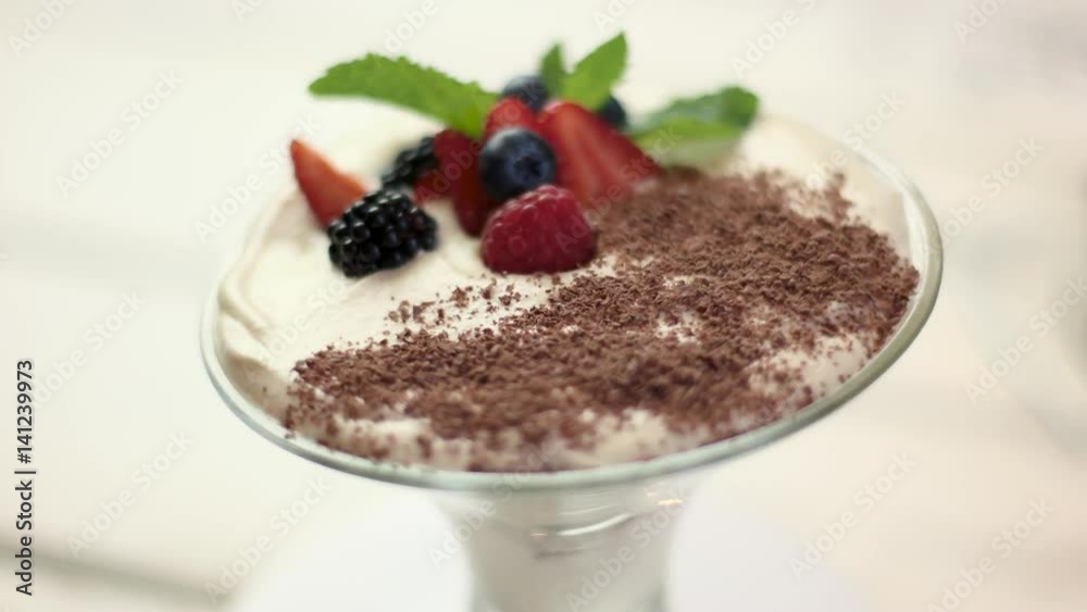 Tiramisu in a glass. Cream, berries and chocolate crumbs. Tiramisu in a glass. Cream, berries and chocolate crumbs.