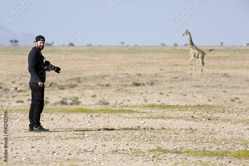 Photographer taking a picture of a giraffe