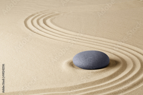 Zen meditation stone garden background. Stone on fine sand standing for balance, harmony concentration and relaxation...
