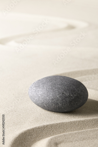 Zen background with stone and line in the sand. Focus on concentration and spirituality for harmony and purity..