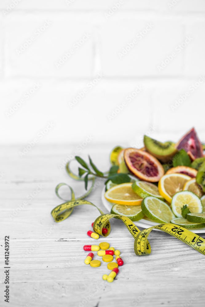 a variety of fruits and measuring tape a variety of fruits and measuring tape