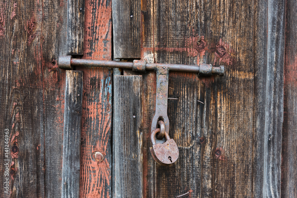The old door locked with a padlock hanging brackets. Set of backgrounds The old door locked with a padlock hanging brackets. Set of backgrounds