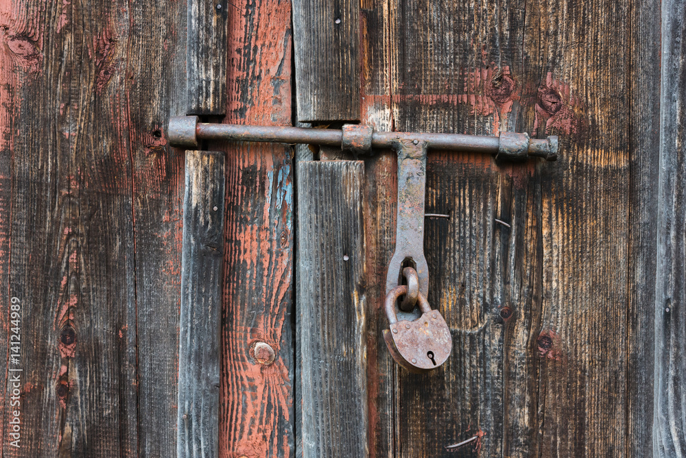 The old door locked with a padlock hanging brackets. Set of backgrounds The old door locked with a padlock hanging brackets. Set of backgrounds