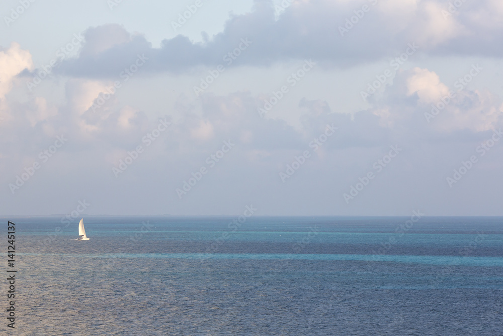 White sailboat in the middle of the ocean. Simplicity. Beautiful wallpaper.