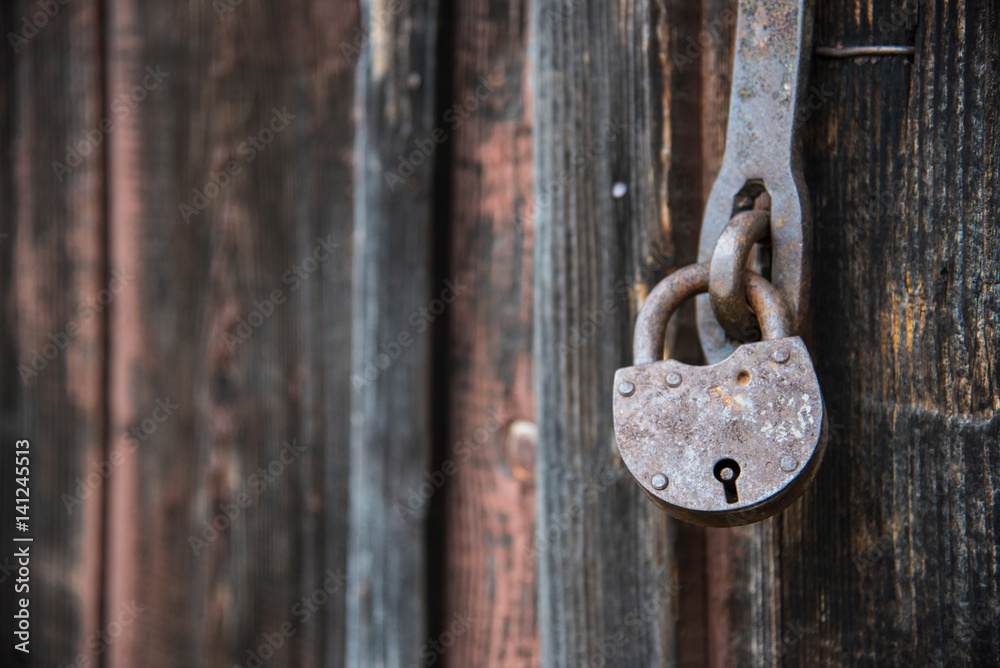 The old door locked with a padlock hanging brackets. Set of backgrounds The old door locked with a padlock hanging brackets. Set of backgrounds