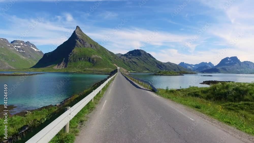 Driving a Car on a Road in Norway Lofoten Driving a Car on a Road in Norway Lofoten