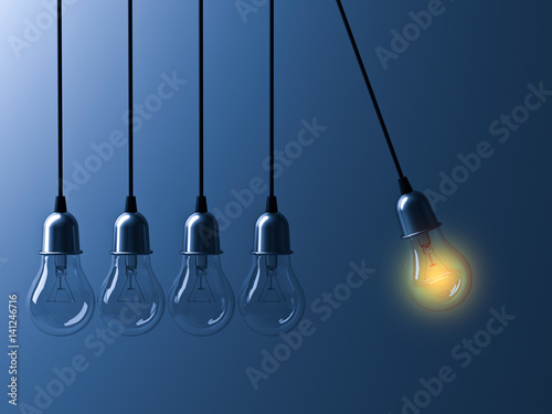 One hanging light bulb glowing different and stand out from unlit incandescent bulbs like newtons cradle on dark blue background, leadership and different business creative idea concept. 3D rendering.