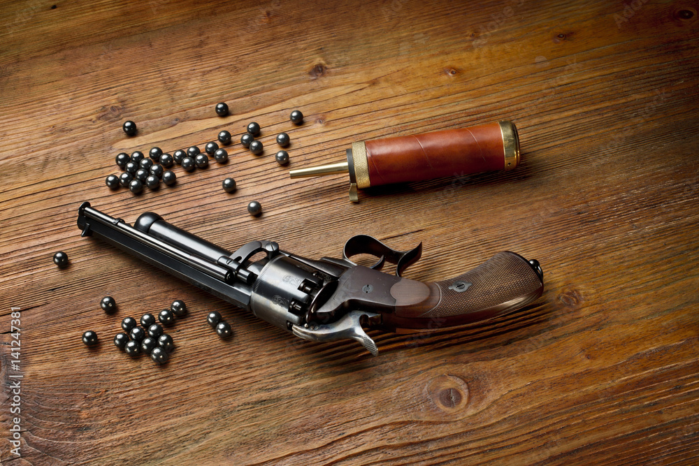  percussion pistol revolver on the wooden table still life with powder box and lead
