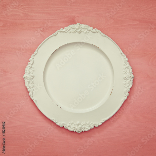 Top view of vintage white empty plate. Flat lay
