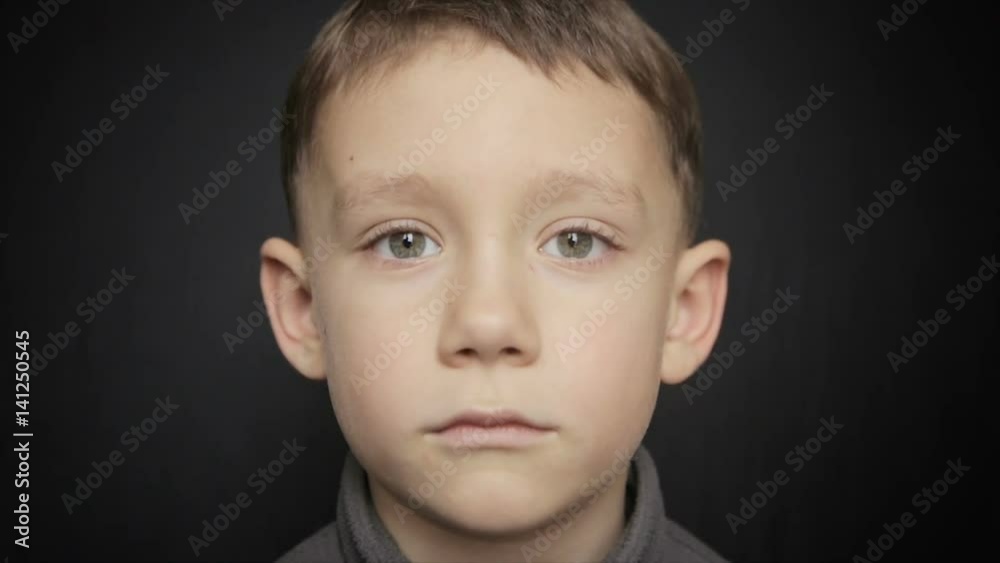 Portrait of a boy close-up on a black background Portrait of a boy close-up on a black background