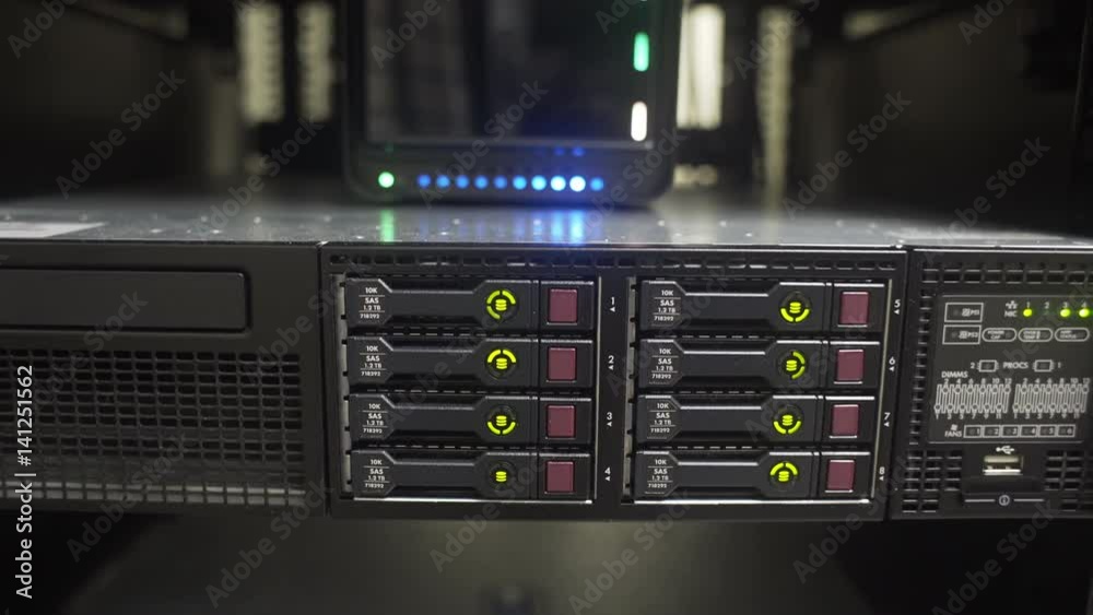 Green LED lights on multiple hard drives of a large corporate network server blink on and off in a alternating pattern. Green LED lights on multiple hard drives of a large corporate network server blink on and off in a alternating pattern.