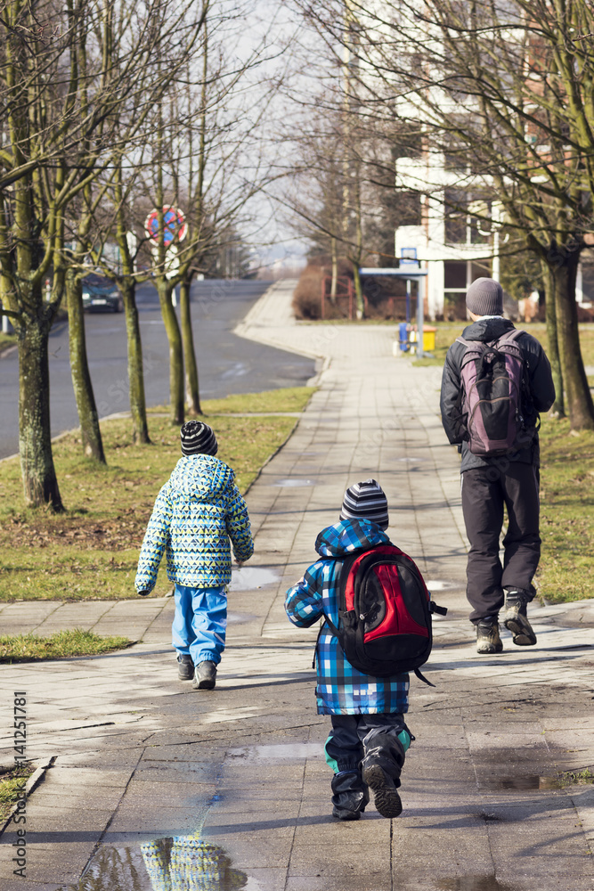 Father and children walking on the street
