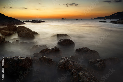 Dramatic seascape of rock and sea in the andaman ocean. Colorful summer sunset in phuket thailand.