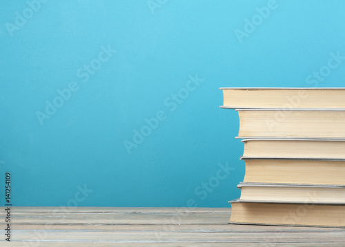 Stack of books on the wooden table. Education background. Back to school.Copy space for text.