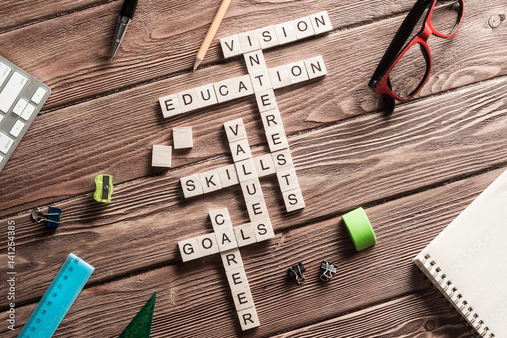 Conceptual keywords on wooden table with elements of game making crossword Conceptual keywords on wooden table with elements of game making crossword