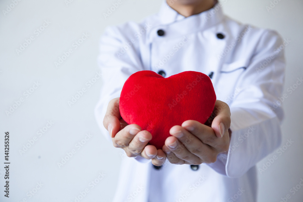 Happy chef holding heart shape with love and passion Happy chef holding heart shape with love and passion