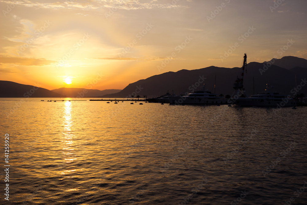 Sunset on the sea, view to sea in the evening. The ships and the mountains