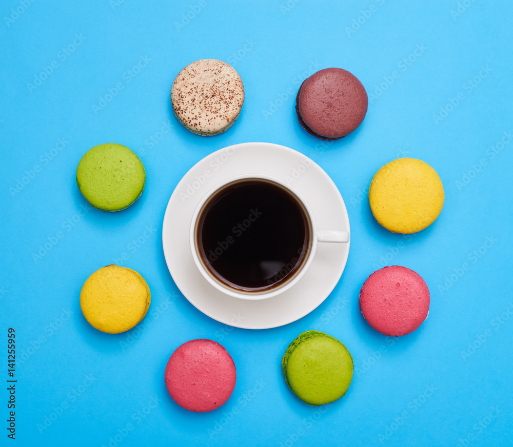 A cup of aroma coffee encircled with a delicious homemade macaroons