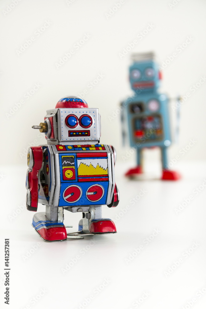 Obraz premium Pair of vintage tin toy robots isolated on white background