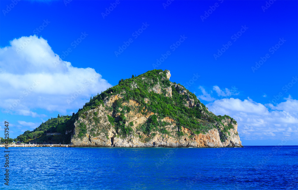 a small island in the calm sea in warm summer day
