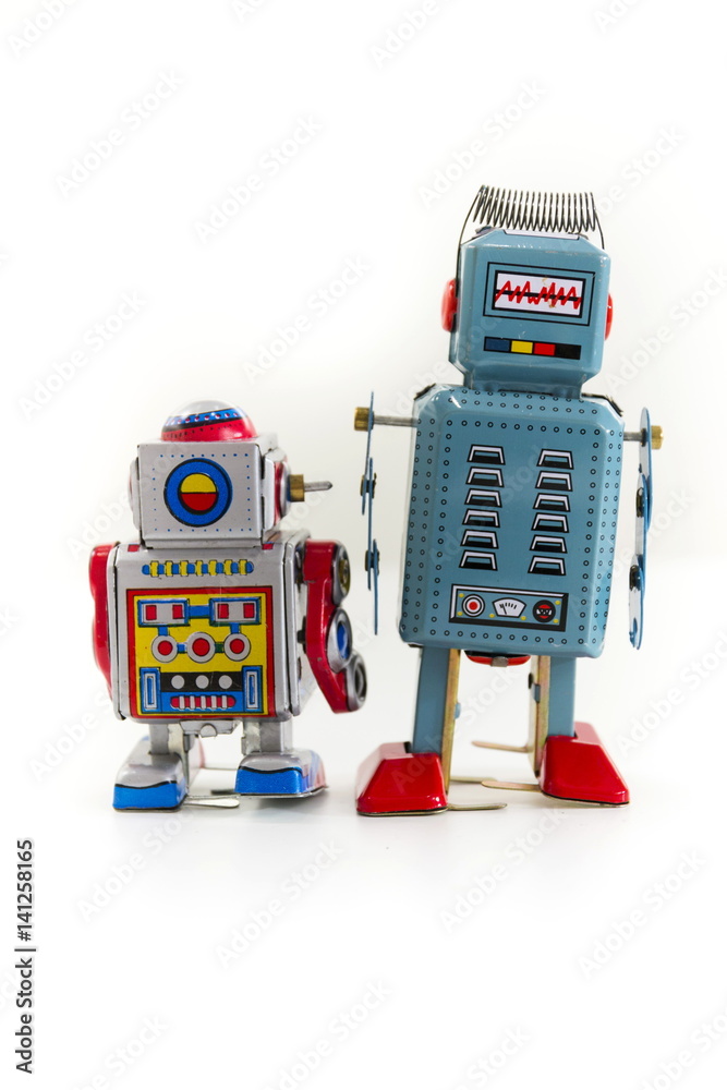 Fototapeta premium Pair of vintage tin toy robots isolated on white background