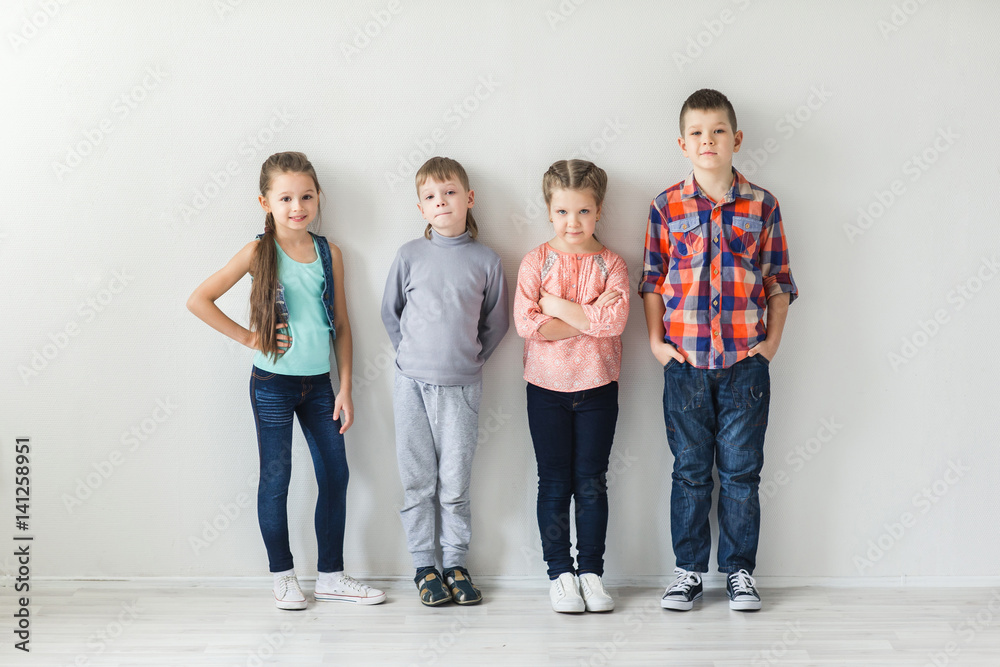 portrait of cute little kids in wear clothes looking at camera and smiling portrait of cute little kids in wear clothes looking at camera and smiling