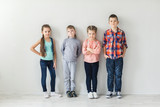 portrait of cute little kids in wear clothes looking at camera and smiling