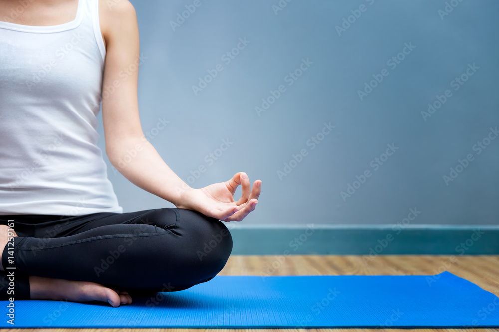 Naklejka premium Asian young woman practicing yoga in the room and sport yoga,yoga in the room,sport yoga,yoga practice,yoga relax
