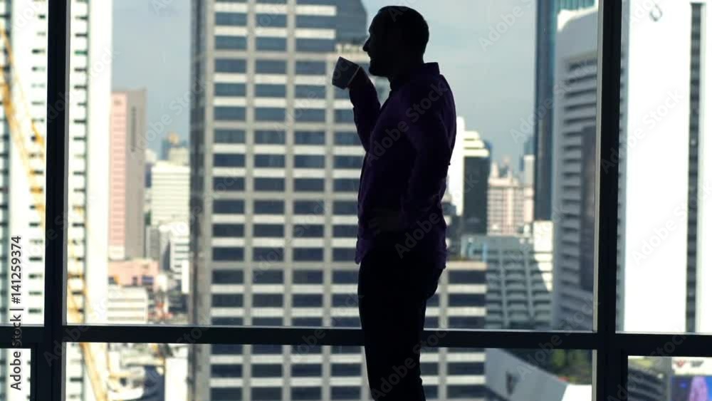 Silhouette of man admire view from window and drinking coffee, super slow motion 120fps
Silhouette of man admire view from window and drinking coffee, super slow motion 120fps