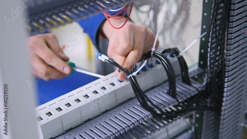 Unrecognizable professional electrician assembling electrical shield. 4K.